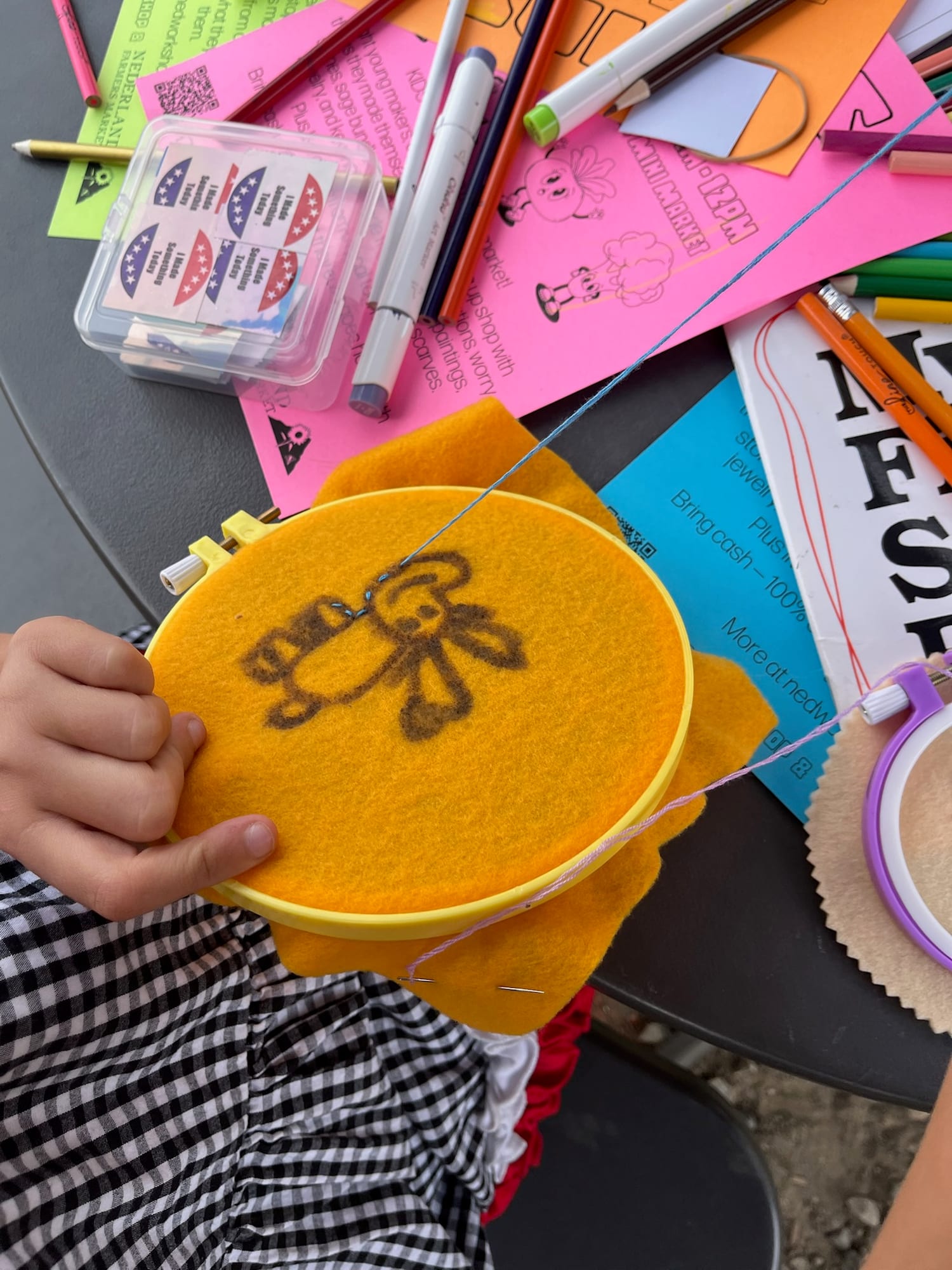 Stitching a bunny drawn onto orange felt