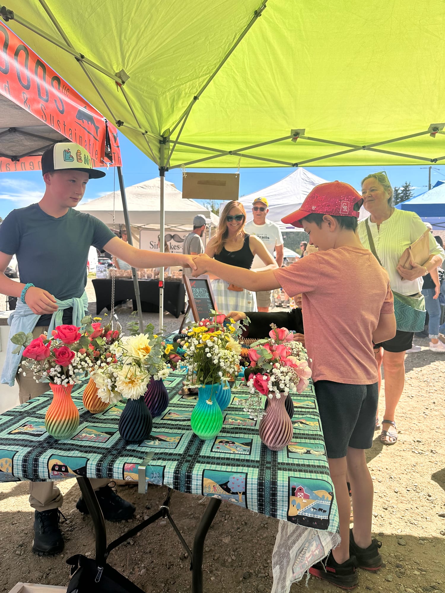 Sealing a sale with a fist bump over 3D printed vases