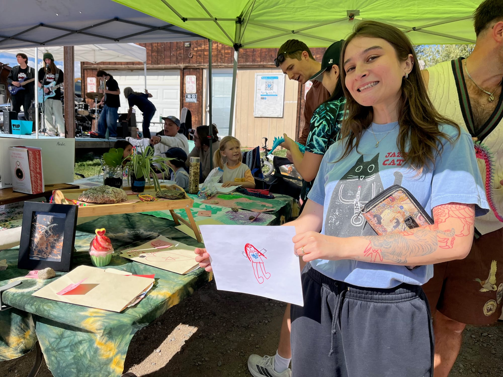 A shopper showing off a portrait drawn to order