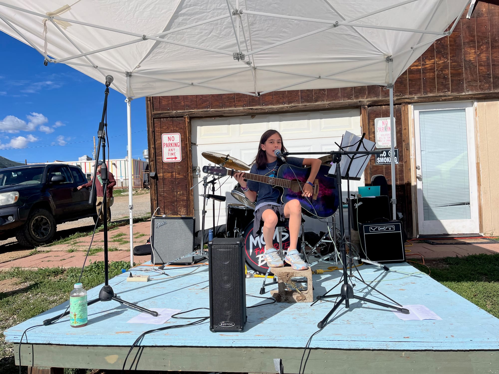 A young musician playing a solo set on the main stage